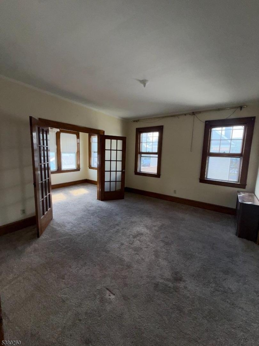 313 Ashton Avenue, Unit 2 Linden, NJ 07036 - Photo 3 of 8 an empty room with windows and closet