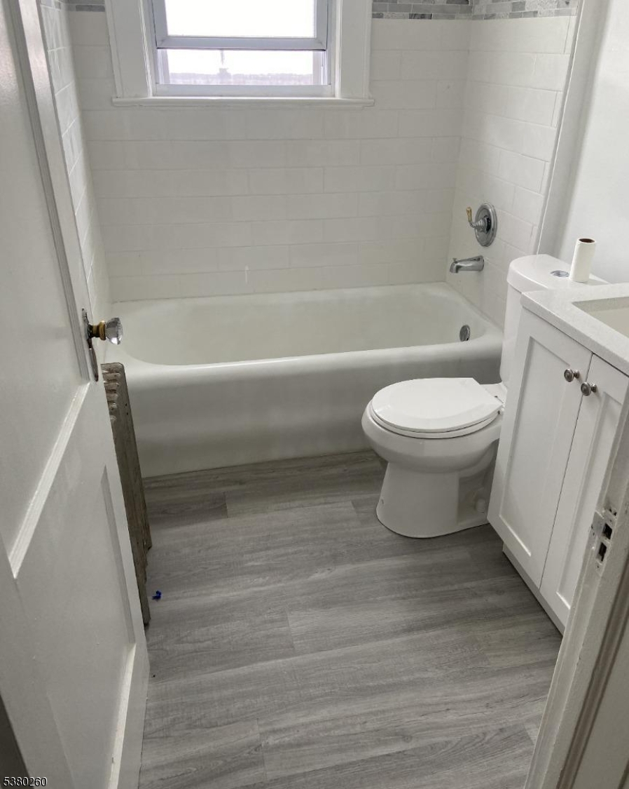 313 Ashton Avenue, Unit 2 Linden, NJ 07036 - Photo 4 of 8 a bathroom with a toilet a sink and bathtub