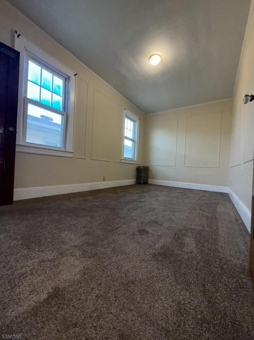 313 Ashton Avenue, Unit 2 Linden, NJ 07036 - Photo 6 of 8 an empty room with windows