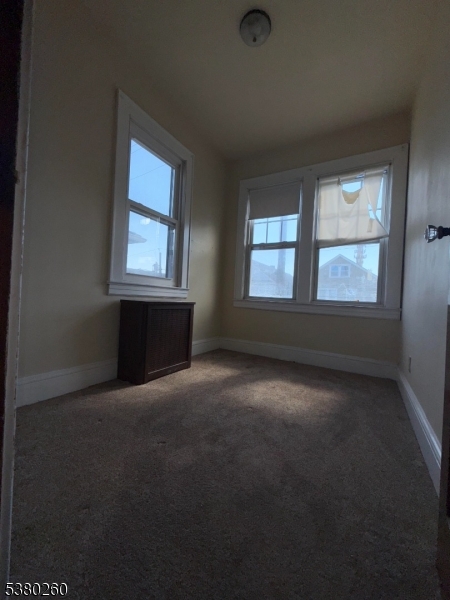 313 Ashton Avenue, Unit 2 Linden, NJ 07036 - Photo 8 of 8 an empty room with windows