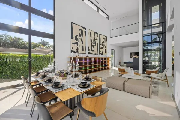 a living room with furniture and large windows