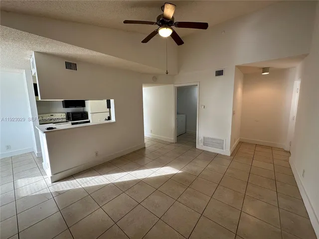 a kitchen with stainless steel appliances a refrigerator and a stove top oven
