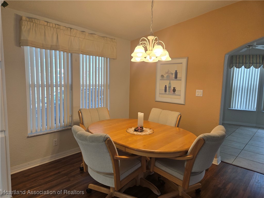 3312 Beartooth Pass Sebring, FL 33872 - Photo 7 of 39 a view of a dining room with furniture window and wooden floor