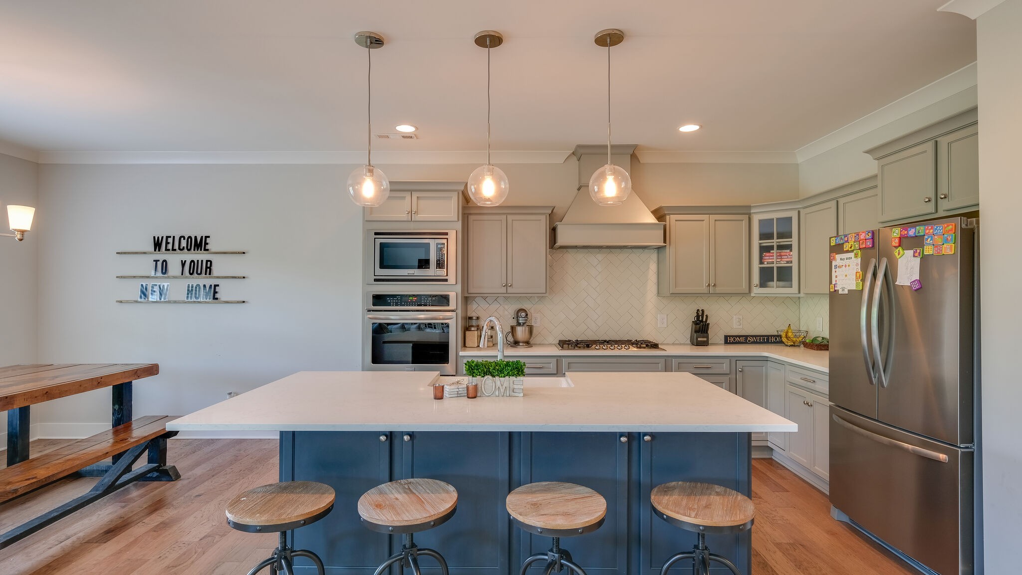 779 Plowson Road Mount Juliet, TN 37122 - Photo 13 of 44 a kitchen with a table a sink refrigerator and microwave