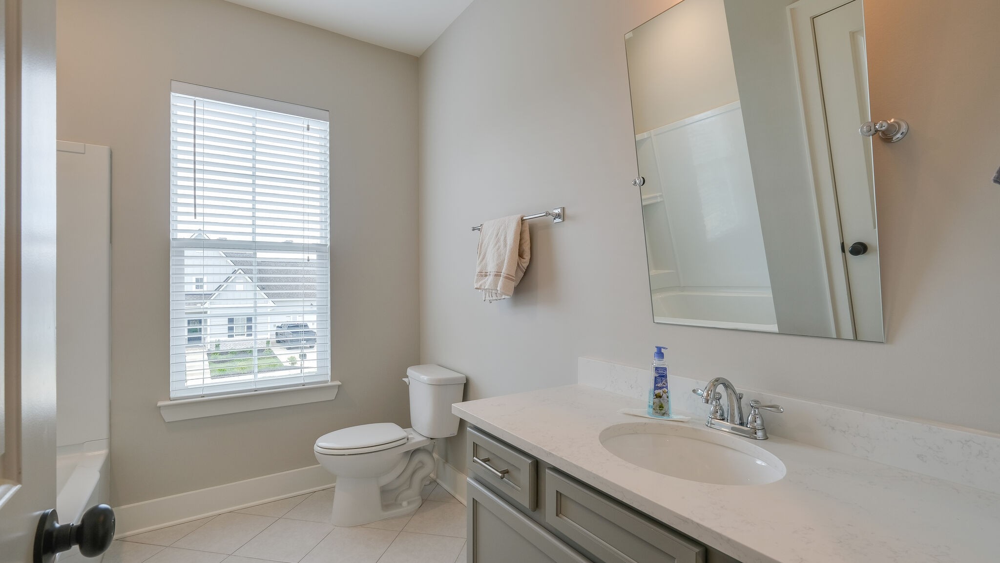 779 Plowson Road Mount Juliet, TN 37122 - Photo 23 of 44 a bathroom with a granite countertop toilet a sink a mirror and a window