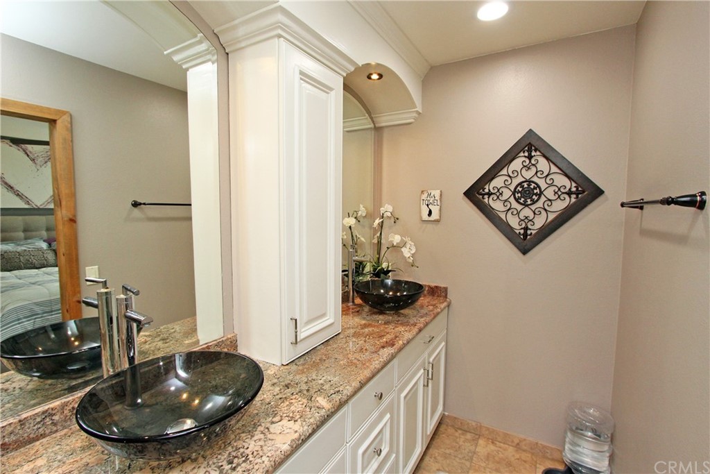 15030 Reedley Street, Unit C Moorpark, CA 93021 - Photo 13 of 23 a bathroom with a granite countertop sink and a mirror