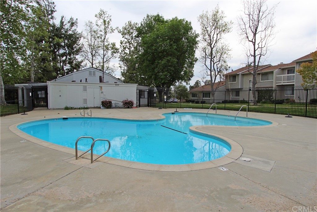 15030 Reedley Street, Unit C Moorpark, CA 93021 - Photo 17 of 23 a view of a swimming pool with a patio and a yard