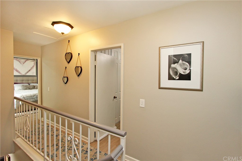 15030 Reedley Street, Unit C Moorpark, CA 93021 - Photo 9 of 23 a view of a hallway with paintings on the wall