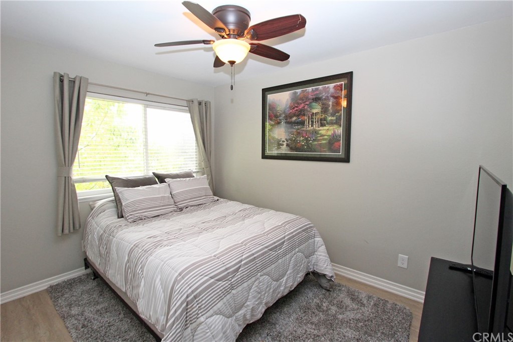 15030 Reedley Street, Unit C Moorpark, CA 93021 - Photo 10 of 23 a bedroom with a bed and a painting on the wall