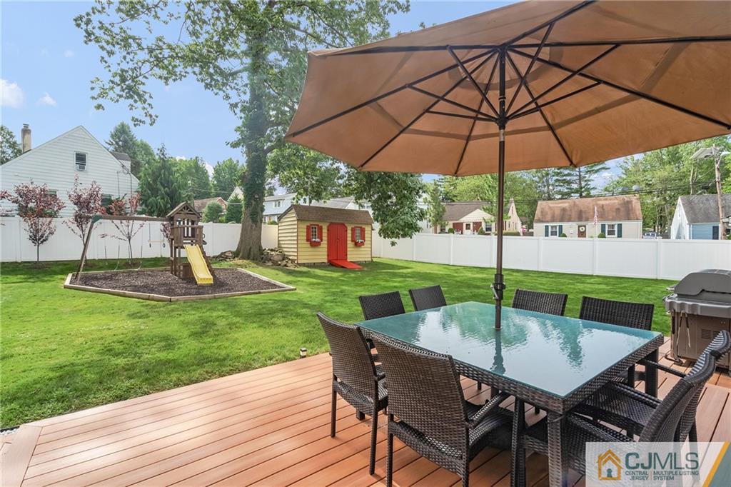151 East Cliff Road Colonia, NJ 07067 - Photo 2 of 29 a view of backyard with sitting space and wooden fence