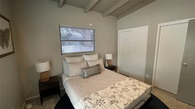 a bedroom with a bed and a chair