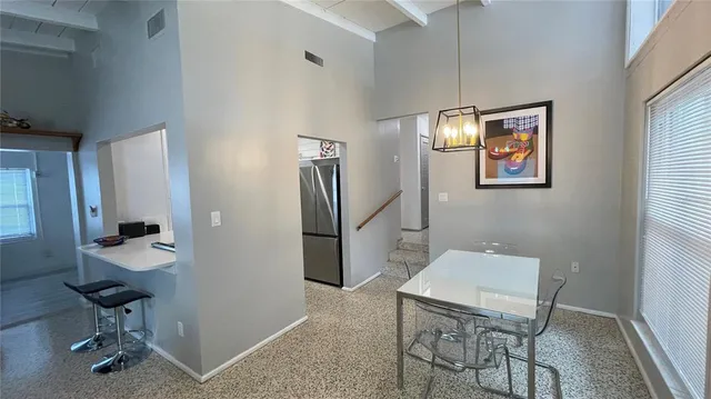 a view of a livingroom with furniture and chandelier fan