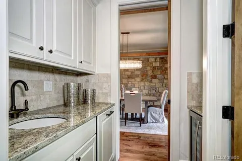 a kitchen with granite countertop a sink and cabinets