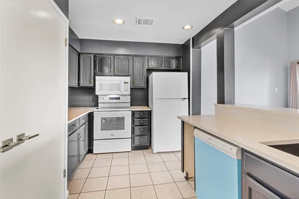 a kitchen with a stove a refrigerator and a sink