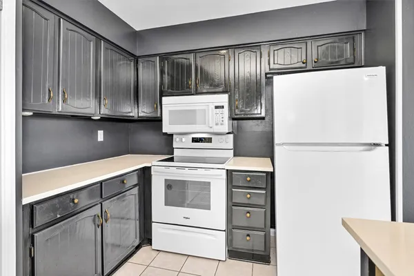 a kitchen with cabinets stainless steel appliances and counter space