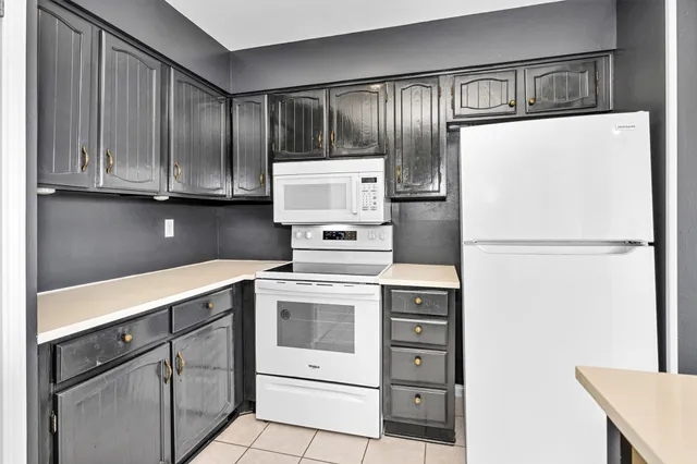 a kitchen with cabinets stainless steel appliances and counter space