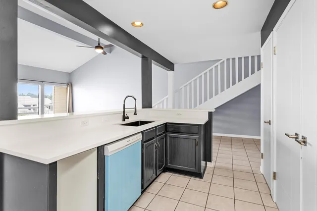 a kitchen with a sink cabinets and window