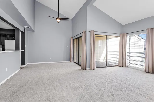 a view of a livingroom with an empty space and a window