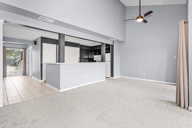 en empty room with fan and windows