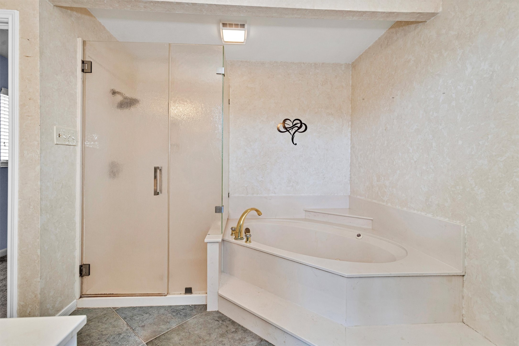 50 April Point Drive South, Unit 50 Conroe, TX 77356 - Photo 25 of 30 a white bath tub sitting next to a shower