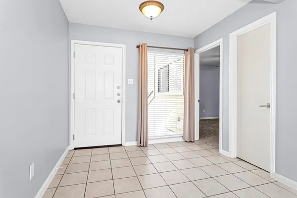 an empty room with windows and closet