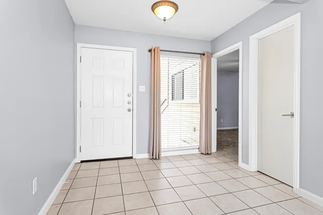 an empty room with windows and closet