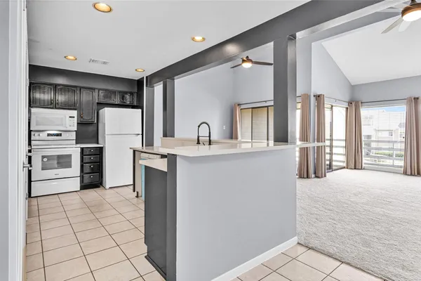 a kitchen with stainless steel appliances a sink and a refrigerator