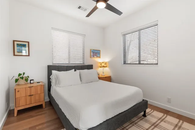 a bedroom with a bed and wooden floor