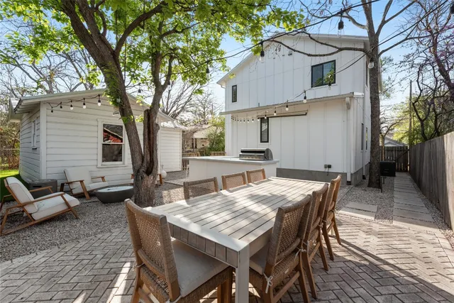 a view of a patio with a table and chairs