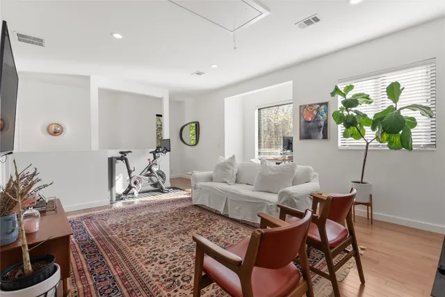 a living room with furniture and a potted plant