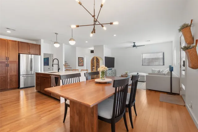 a kitchen with kitchen island a counter space a stove and a chandelier