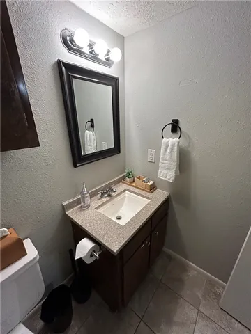 a bathroom with a sink a mirror and a toilet