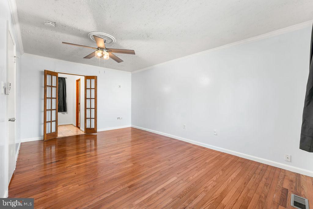 4924 Plata Street Clinton, MD 20735 - Photo 15 of 26 wooden floor in an empty room with a window