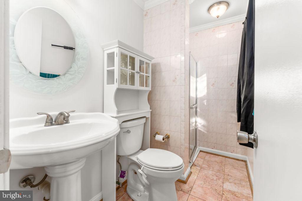 4924 Plata Street Clinton, MD 20735 - Photo 16 of 26 a bathroom with a sink a toilet and a mirror