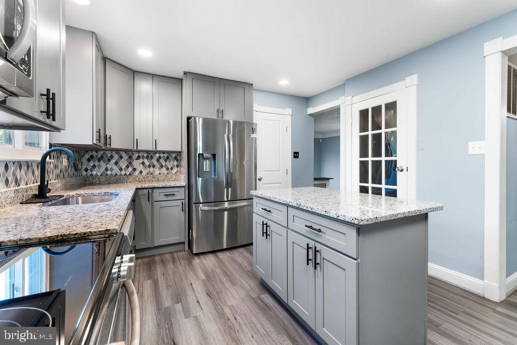4924 Plata Street Clinton, MD 20735 - Photo 2 of 26 a kitchen with a sink stove and refrigerator