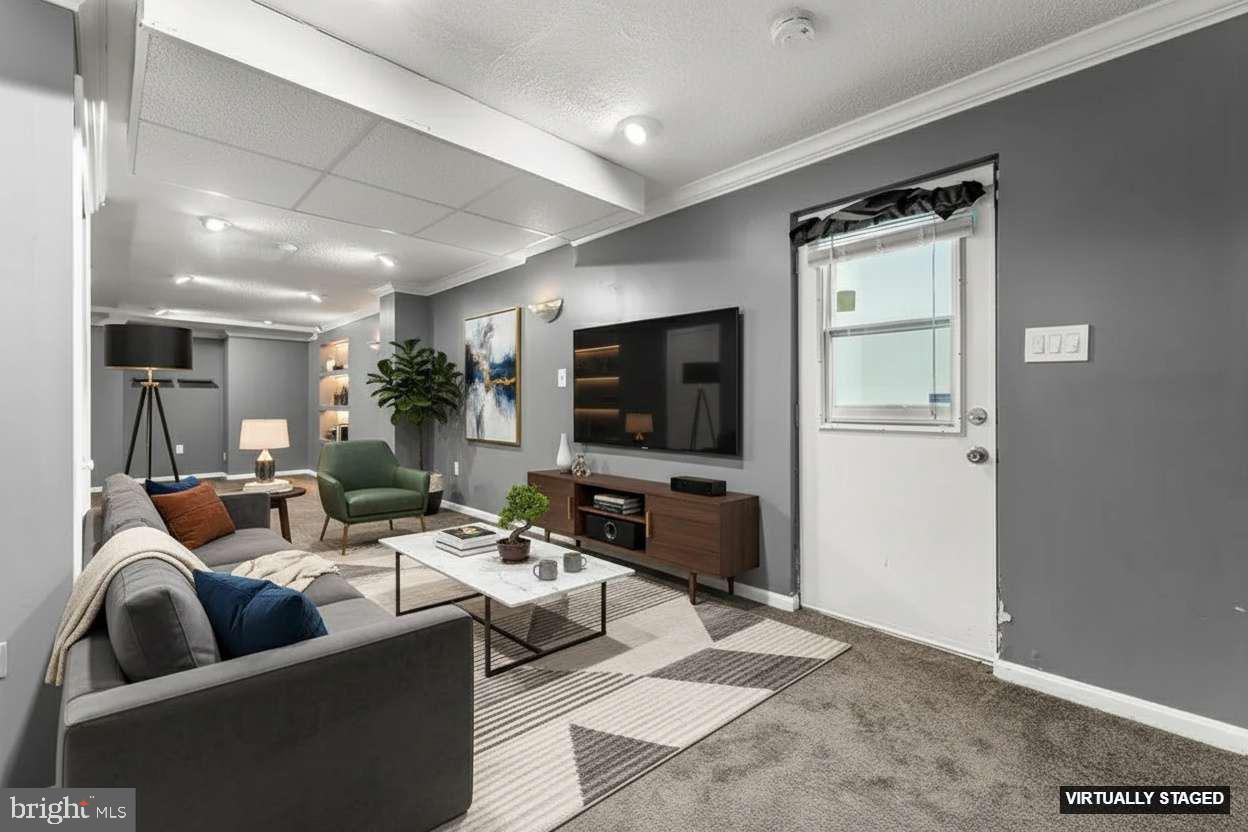 4924 Plata Street Clinton, MD 20735 - Photo 20 of 26 a living room with furniture and a flat screen tv