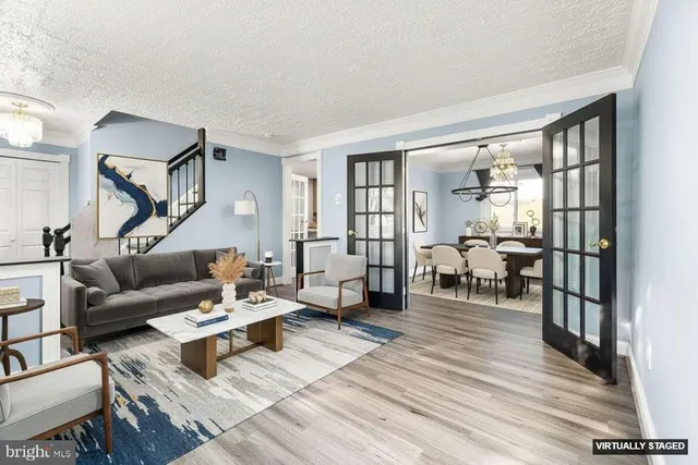 a living room with furniture and a table with wooden floor