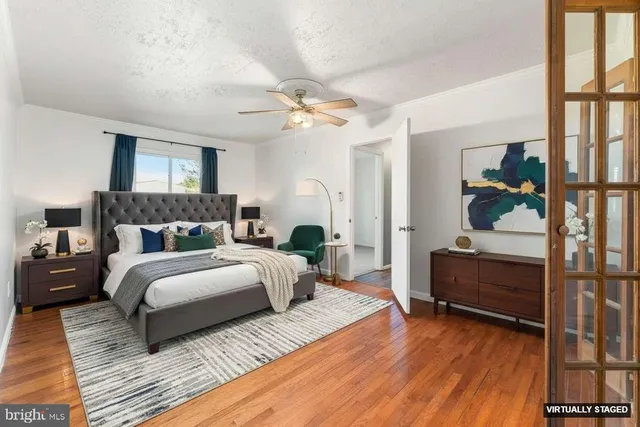 a spacious bedroom with a bed and a chandelier