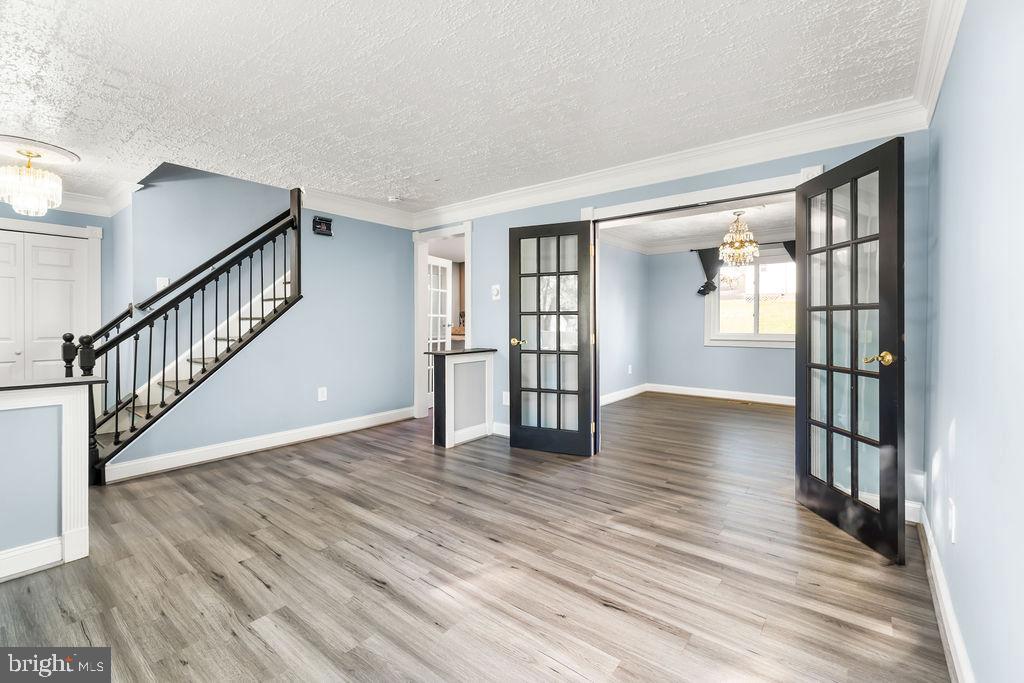 4924 Plata Street Clinton, MD 20735 - Photo 6 of 26 a view of an empty room with wooden floor and a window