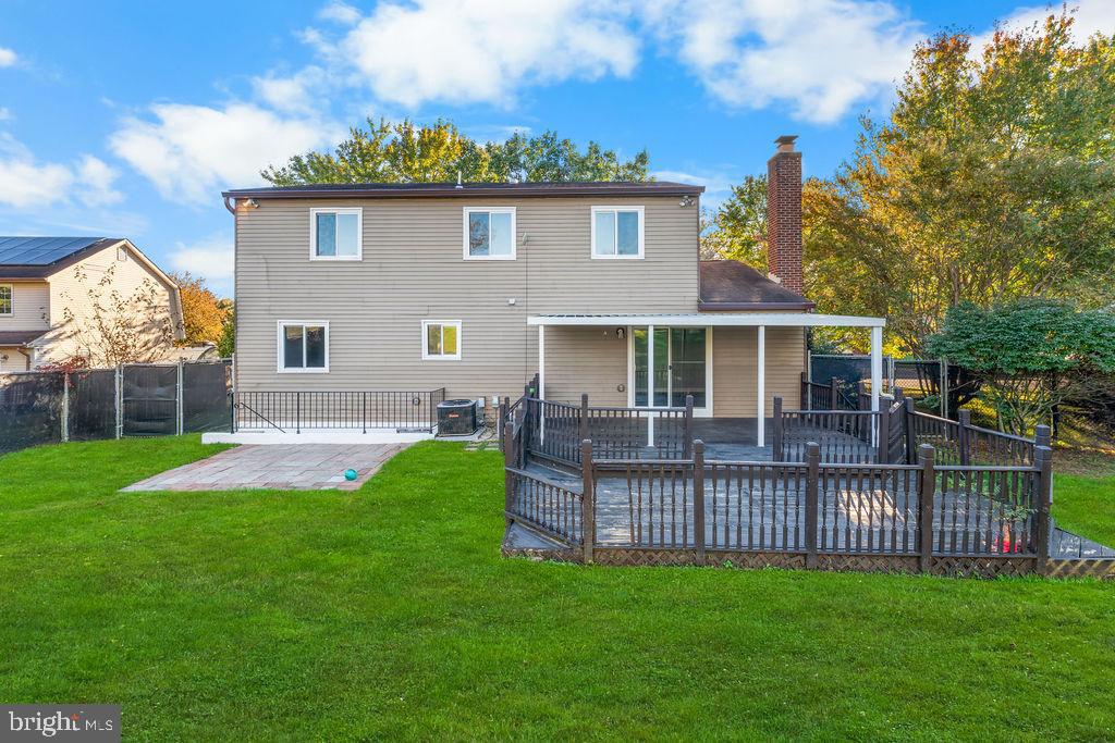 4924 Plata Street Clinton, MD 20735 - Photo 8 of 26 a view of a house with a yard and a deck