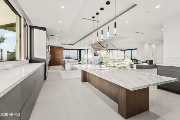 a living room with furniture and a kitchen