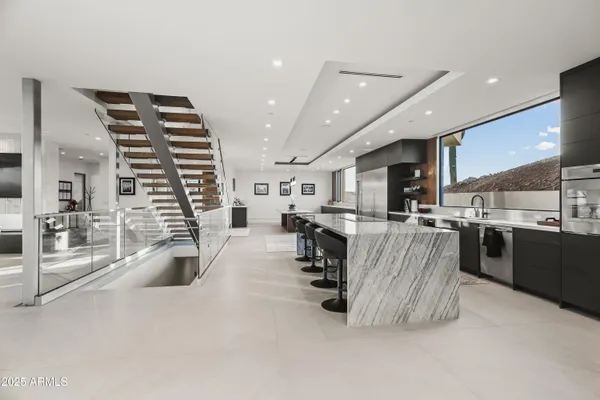 a spacious bedroom with a large bed and a large window