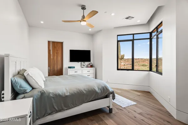 a living room with furniture and a floor to ceiling window