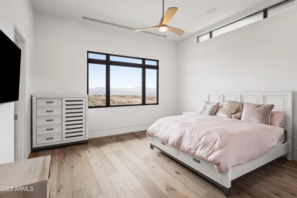 a bedroom with a large bed and a painting