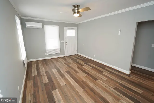 wooden floor in an empty room with a window