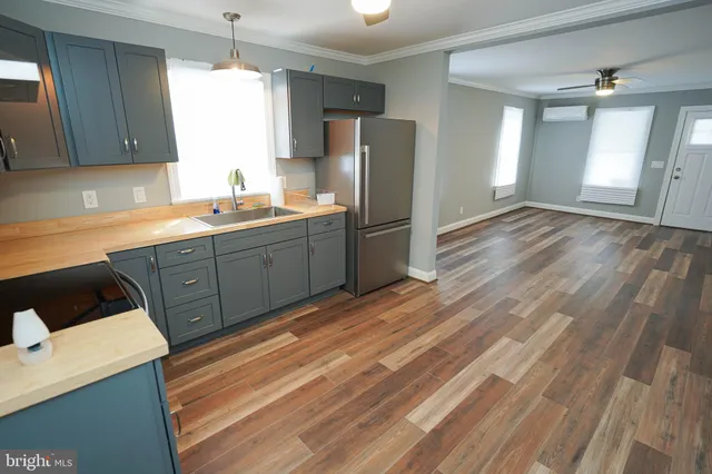 a kitchen with stainless steel appliances a refrigerator and a sink