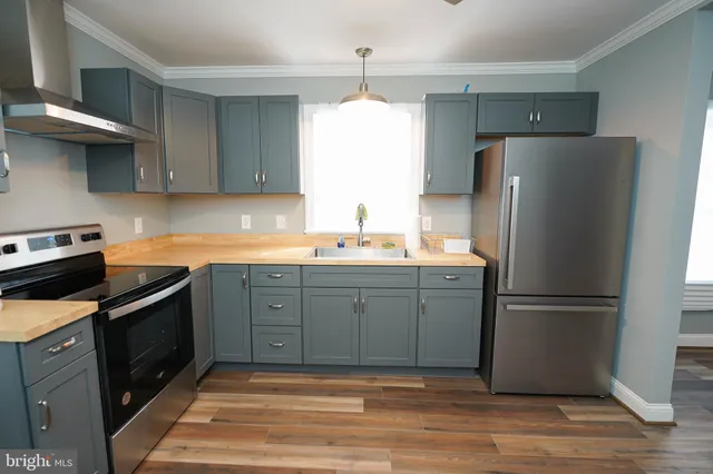 a kitchen with a refrigerator stove and sink
