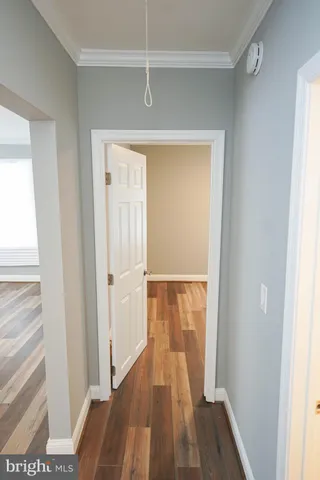 a view of a room with wooden floor