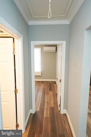 a view of a room with wooden floor a ceiling fan