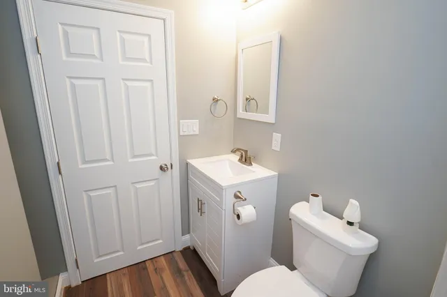 a bathroom with a sink mirror and toilet